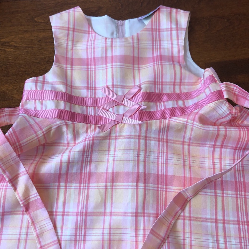 Sweet little pink plaid dress with pink bows